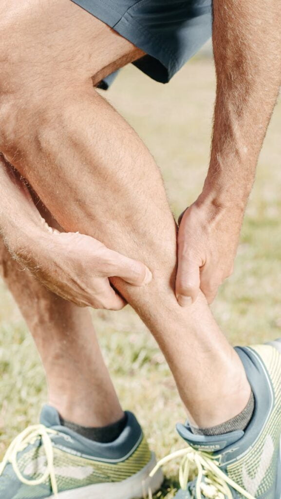 Man Massaging his Calf Muscles