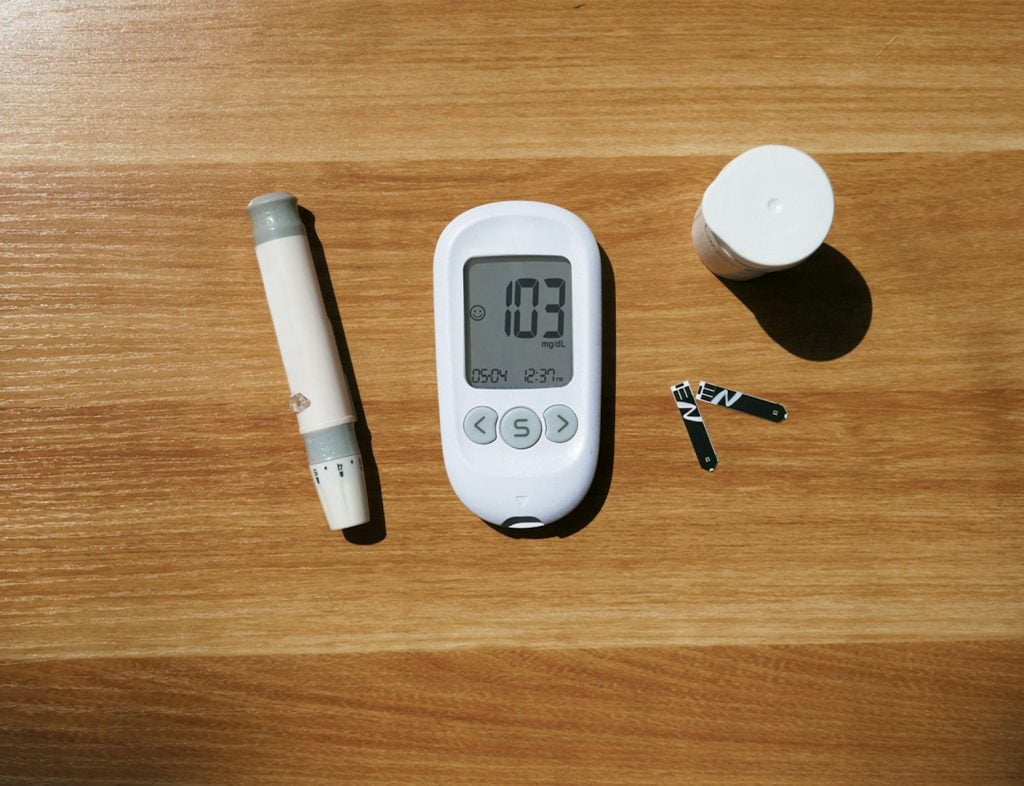 a thermometer, a pen, and a cup on a table